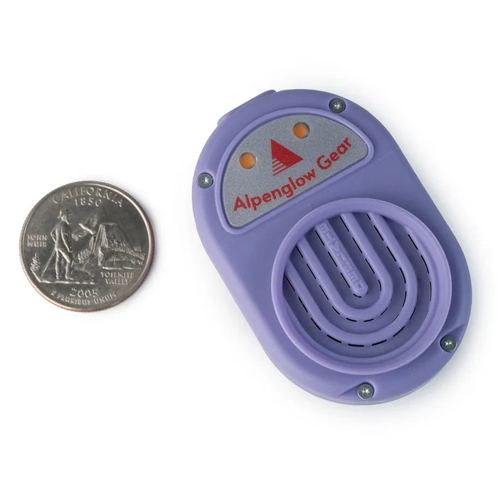 Alpenblow Lux Micro Inflator by Alpenglow Gear next to a quarter for scale