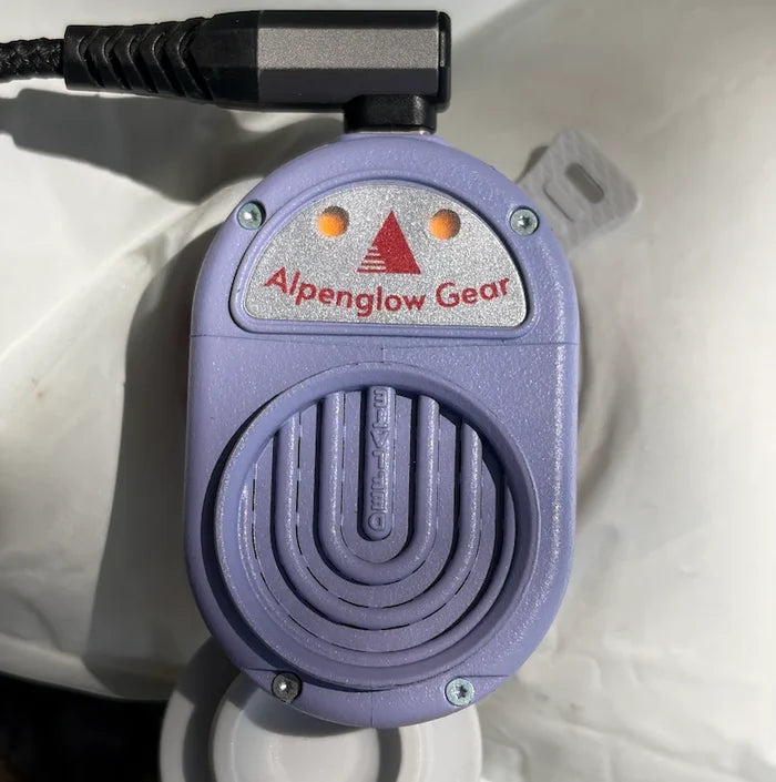 Alpenblow Lux Micro Inflator attached to a sleeping pad valve, USB-C powered – close-up