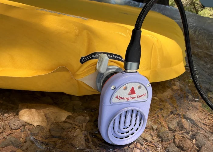 Alpenblow Lux Micro Inflator inflating a yellow Therm-a-Rest sleeping pad outdoors