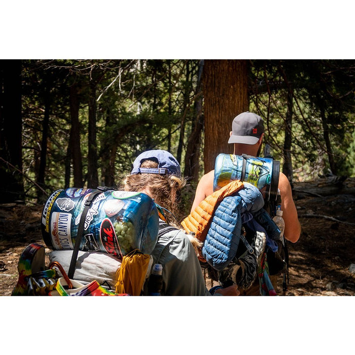 BearVault BV500-Journey canister being packed into a backpack on the trail