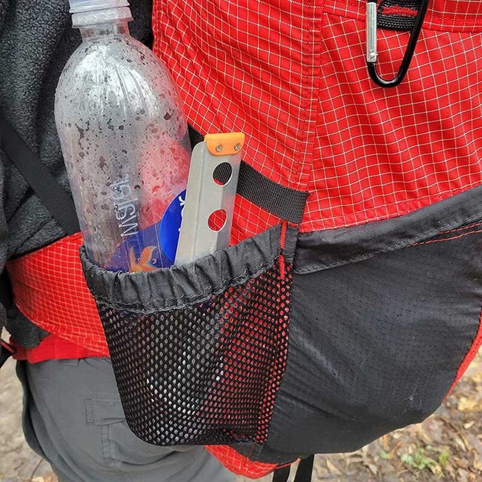 BoglerCo Ultralight Trowel stowed in a hip-belt pocket while worn on the trail