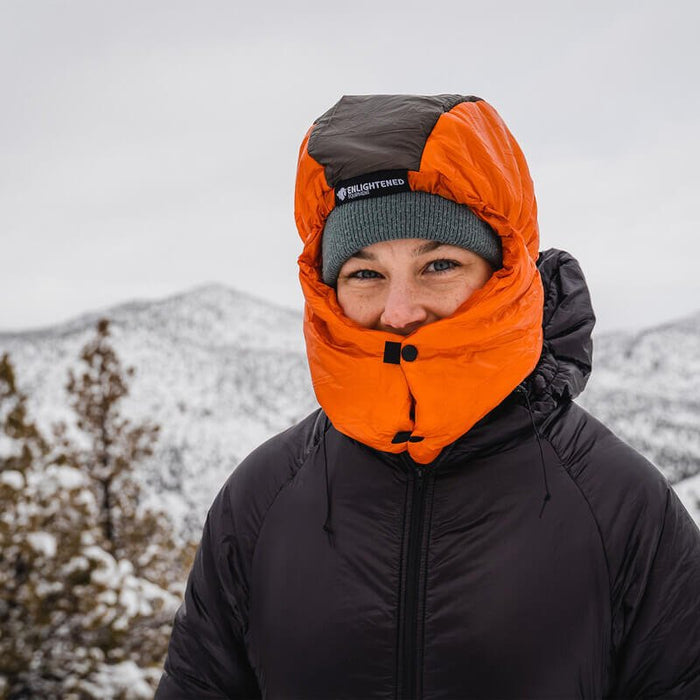 Enlightened Equipment Torrid Hood worn by a person, cinched around the face, in snow