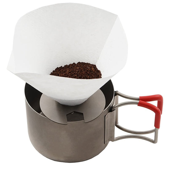 EVERNEW Ti Drip Ring – ring holding a coffee filter with grounds over a cup, studio view
