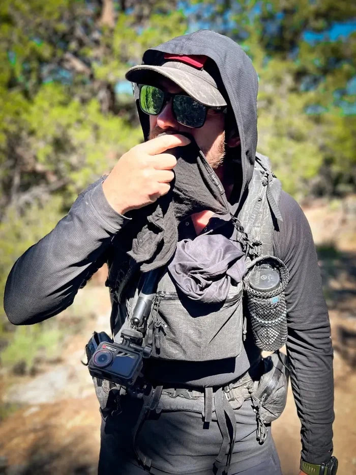 Glacial Gear Trail Rag Elite in use by a hooded hiker with a backpack on the trail