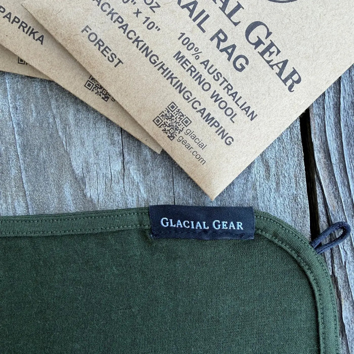 Glacial Gear Trail Rag Elite in forest green, corner detail with woven label and merino tag