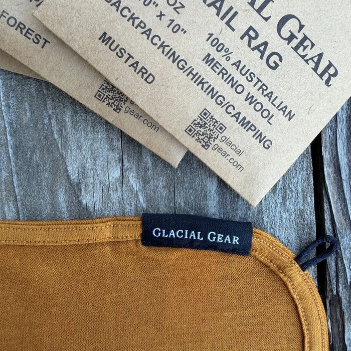 Glacial Gear Trail Rag Elite in mustard, corner detail with woven label and merino wool tag