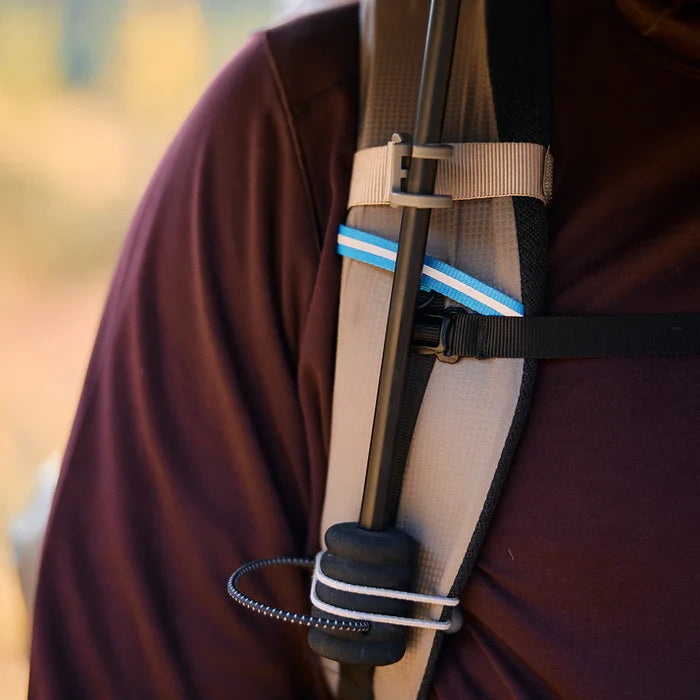 Gossamer Gear Handsfree Umbrella Clamp attached to a backpack shoulder strap, holding an umbrella pole