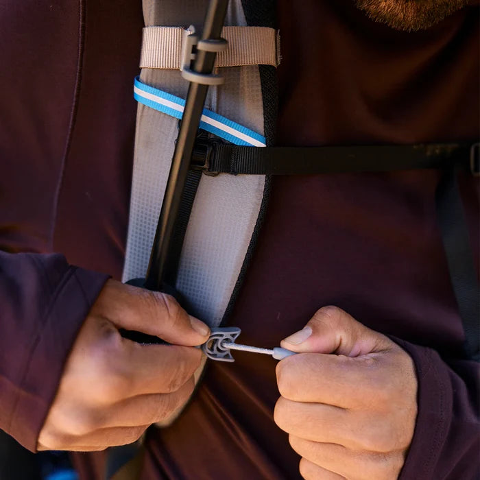 Gossamer Gear Handsfree Umbrella Clamp – hands adjusting the elastic cord toggle on a shoulder strap