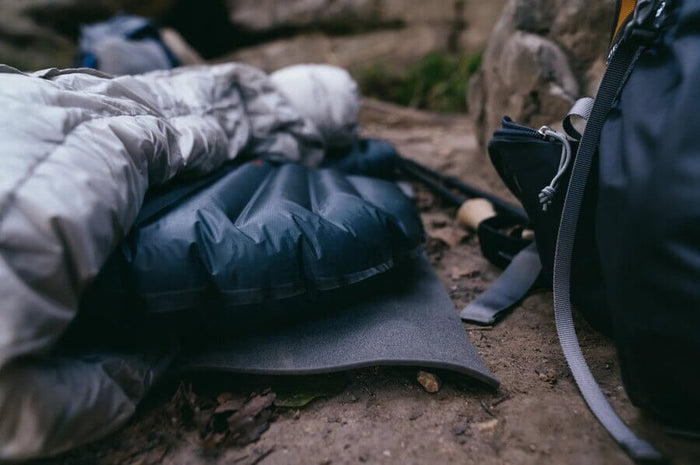 Gossamer Gear Thinlight Foam Pad 1/8" under an inflatable pad and quilt at a forest campsite