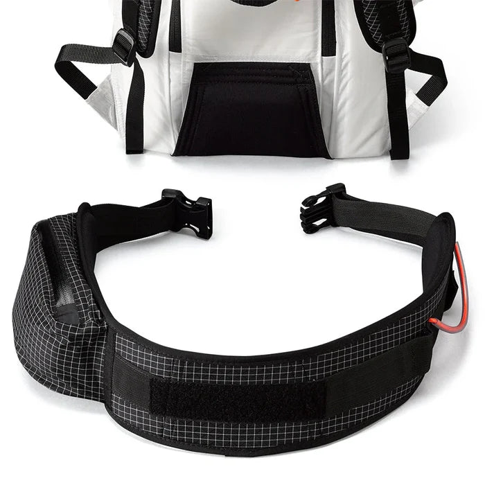 HMG Removable hipbelt shown detached from a white backpack, studio view