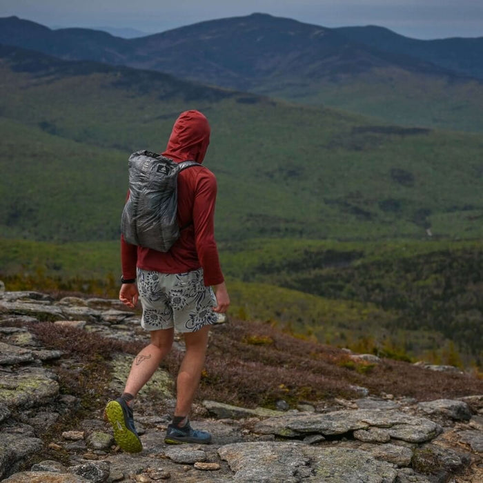 HMG Stuff Pack worn by a hiker looking out over a mountain ridge