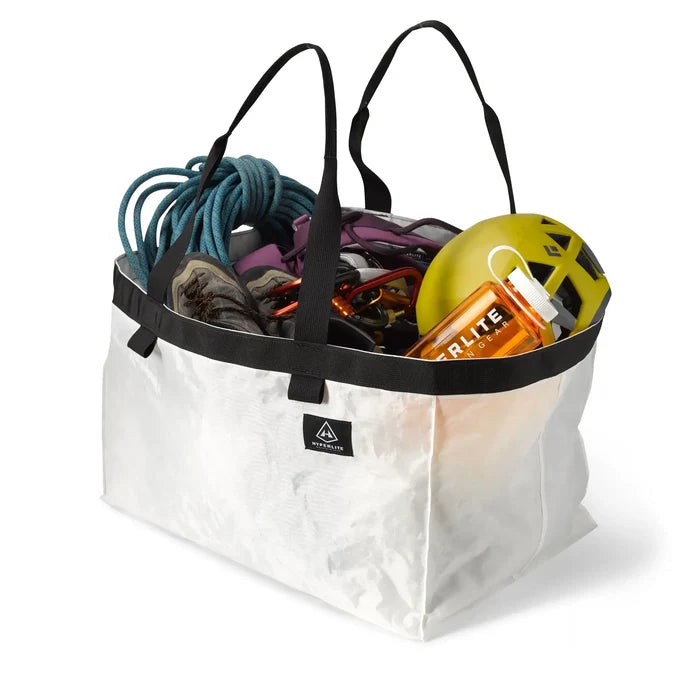 Hyperlite Mountain Gear G.O.A.T. Tote in white, packed with climbing rope, shoes, harness, and a water bottle