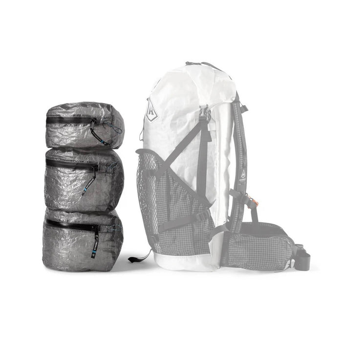 Hyperlite Mountain Gear PODS – stack of three pods beside a ghosted pack outline showing how they fit