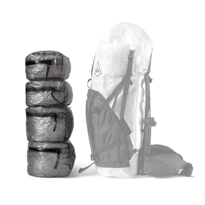Hyperlite Mountain Gear PODS – stack of four pods beside a ghosted taller pack outline showing fit
