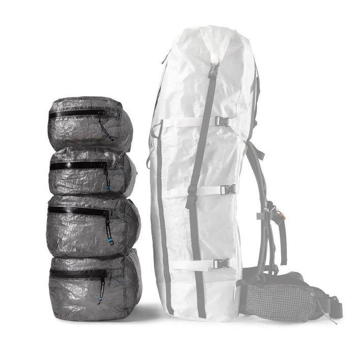Hyperlite Mountain Gear PODS – stack of four pods beside the ghosted outline of the tallest pack size