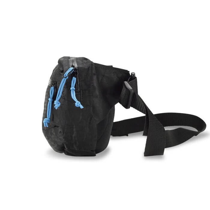 Hyperlite Mountain Gear Versa hip pack worn at the waist, hiker pulling a map from the front pocket
