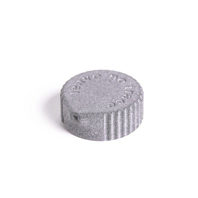 Igneous Bottle Cap Bidet – grey cap, angled studio view of the nozzle top