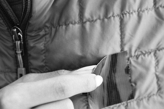 Igneous UL Gorilla Tape Spool – applying a tape strip to a quilted jacket