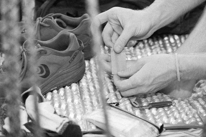 Igneous UL Leuko Tape Spool – applying tape to gear at a campsite
