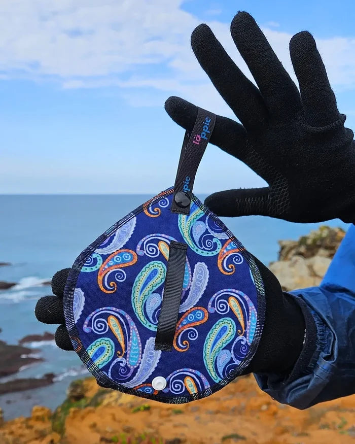 Läppie Pee Cloth in Fiesta print – held in a gloved hand outdoors