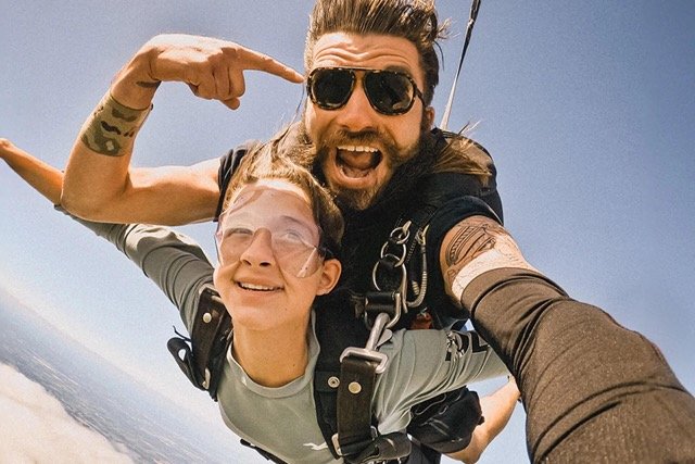 Ombraz Classic armless sunglasses worn by skydivers mid-air