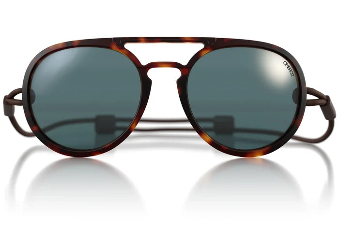 Ombraz Dolomite armless sunglasses, tortoise frame with grey lenses – flat lay with attached cord