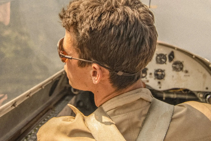 Ombraz Leggero armless sunglasses worn by a person looking out from a small aircraft