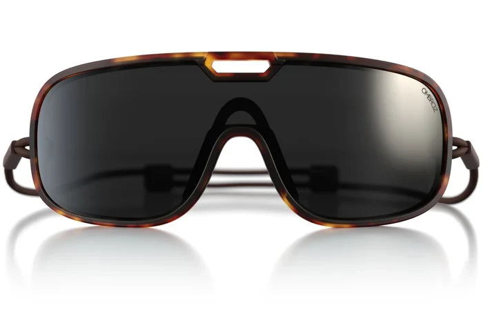 Ombraz Refugio armless sunglasses, tortoise frame with black-mirror lenses – front studio view