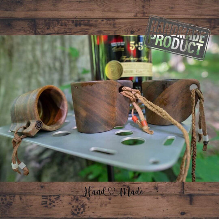 Outdoorline Handcrafted Wooden Shot Glass – on a camp table outdoors