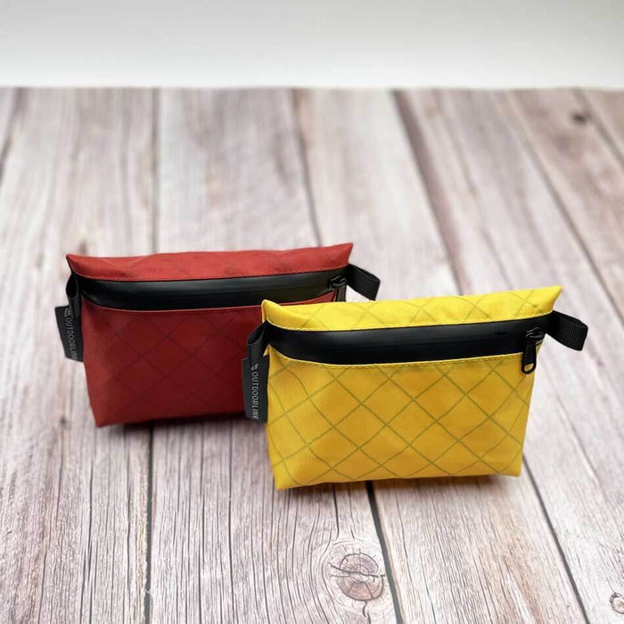 Outdoorline Zipper Pouch Small Ecopak – red and yellow pouches on wood