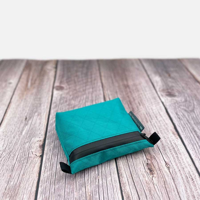 Outdoorline Zipper Pouch Small Ecopak – teal pouch on wood