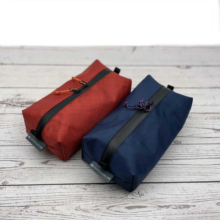 Outdoorline Zipper Pouch Wide Ecopak – red and navy pouches on wood