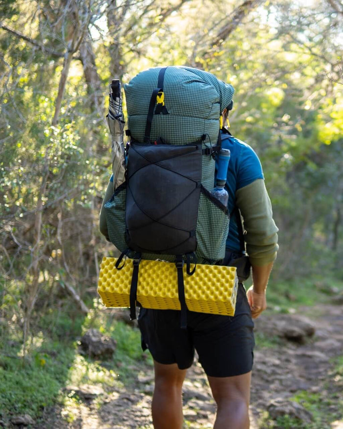 ULA backpack strap kit in use – hiker on trail, rear view