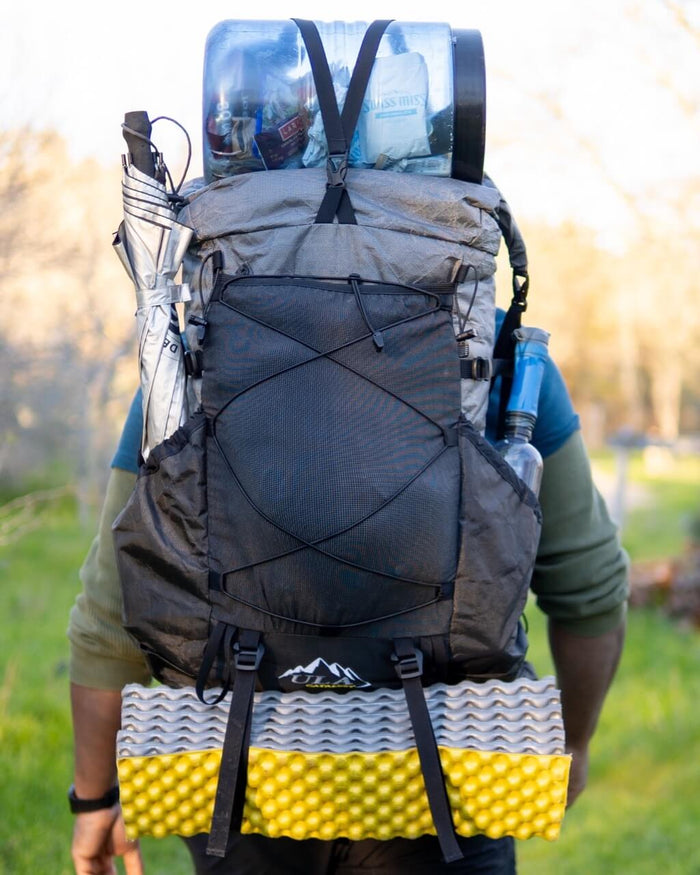 ULA backpack strap kit – worn pack with gear strapped at base