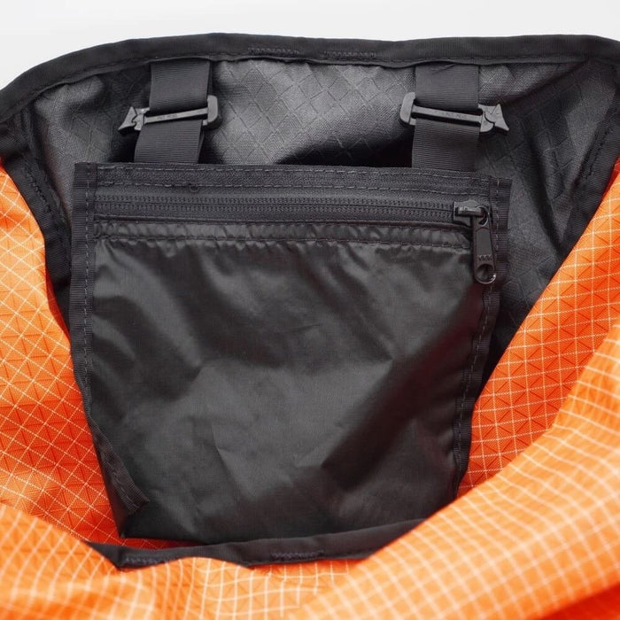 ULA Internal Stash Pocket clipped inside an orange ULA pack, viewed from above