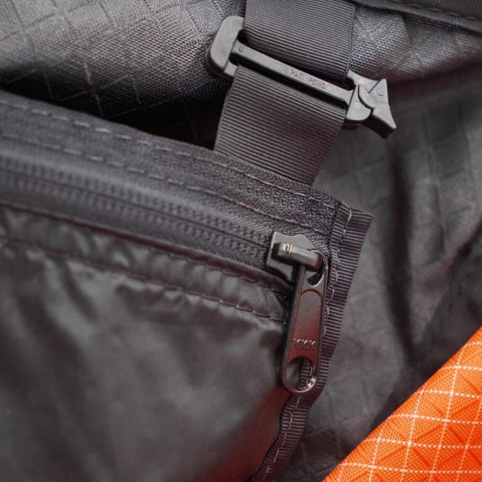 ULA Internal Stash Pocket – close-up of the zip pull and hook buckle attachment inside a pack