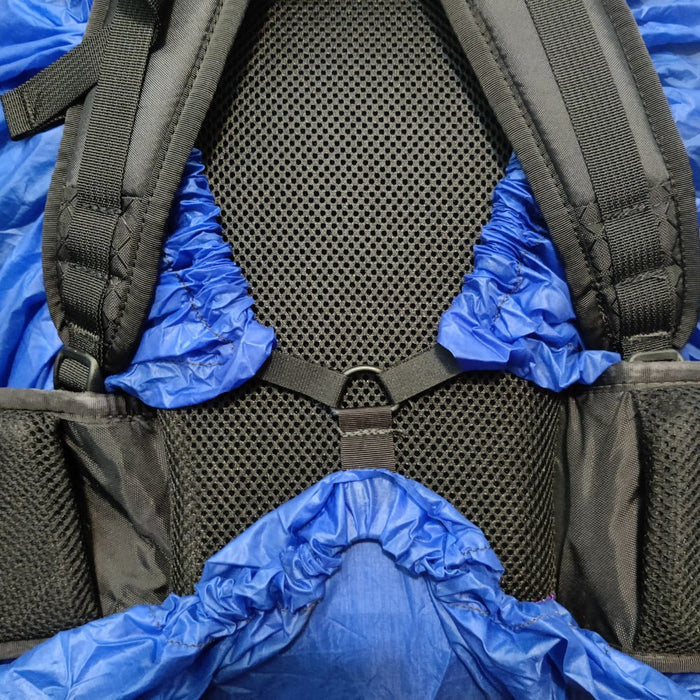 ULA Pack Cover in blue – elasticated edge tucked around the shoulder harness and back panel