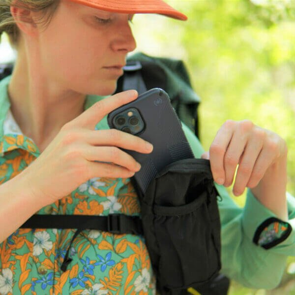 ULA Shoulder Strap Pocket in use – hiker taking a phone from the pocket on her shoulder strap