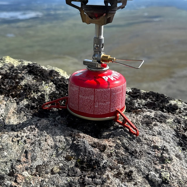 UltimaPeak MagFeets in orange – on a canister with stove, outdoors