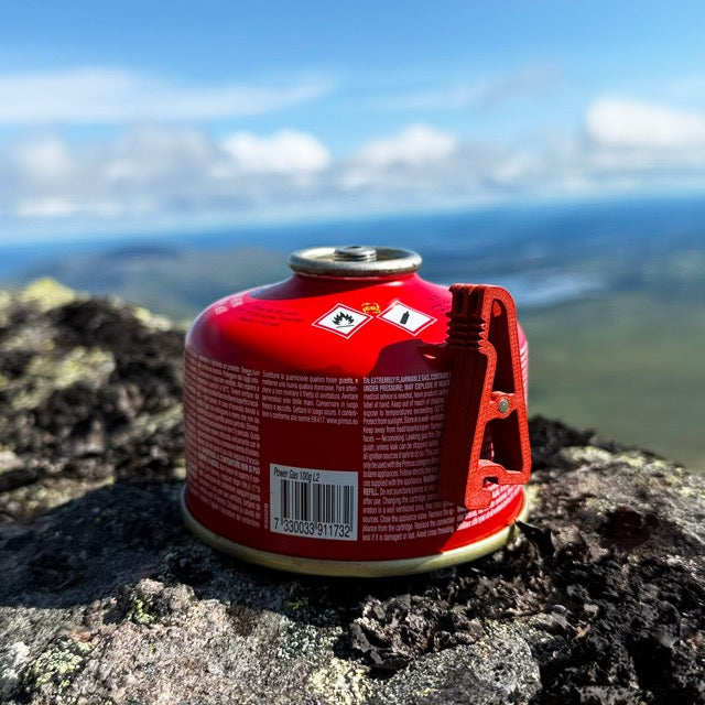 UltimaPeak MagFeets in orange – on a canister outdoors, front