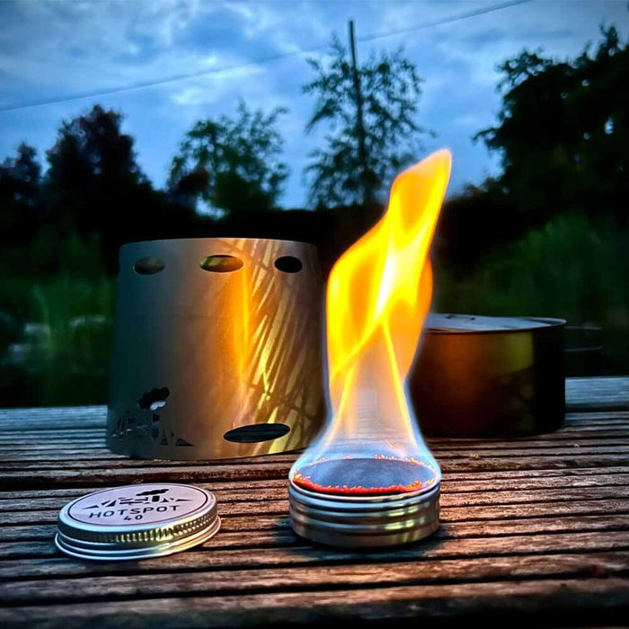 VESUV HOTSPOT 40 alcohol stove burning under a windshield outdoors at dusk