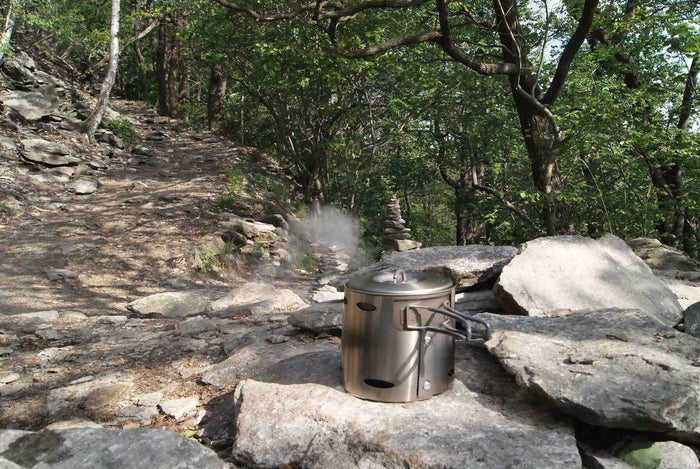 VESUV Titanium Windshield 1,3 L cooking on a pot outdoors on forest rocks