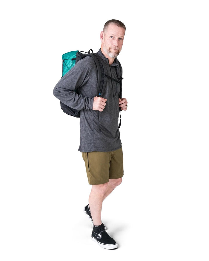 Zpacks Travel & Trail Convertible Hiking Pants in olive – shorts, worn with a pack